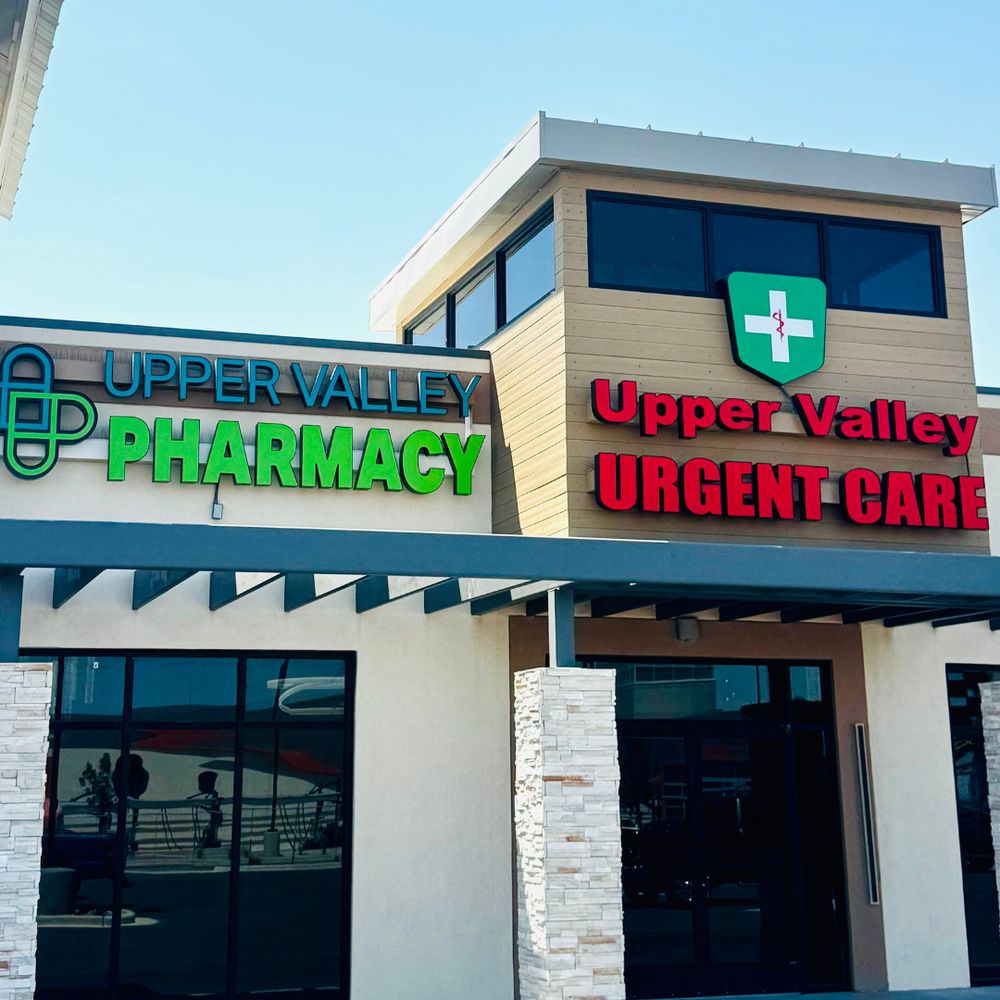 Upper Valley Pharmacy and Upper Valley Urgent Care signs above the building entrance