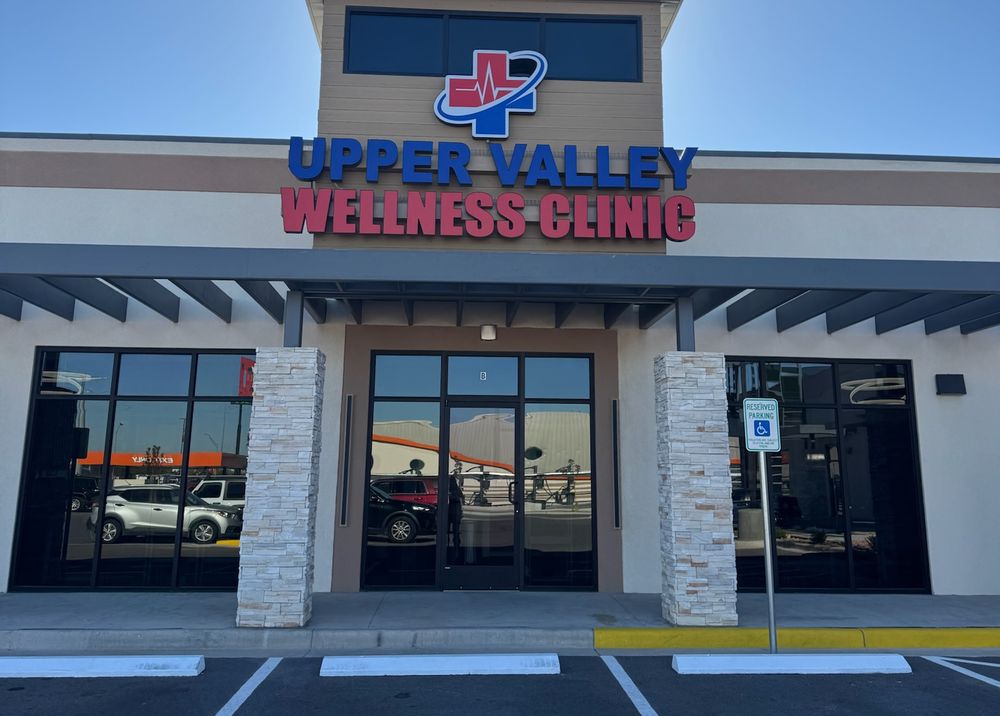 Front of the Upper Valley Wellness Clinic building with its red and blue sign